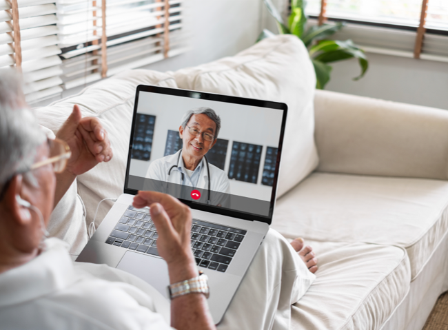 Man at home on video chat with doctor