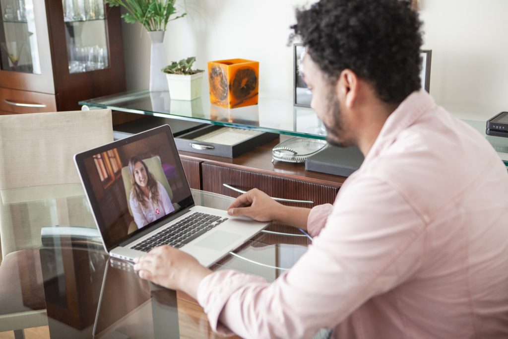 young man consulting with a healthcare professional online
