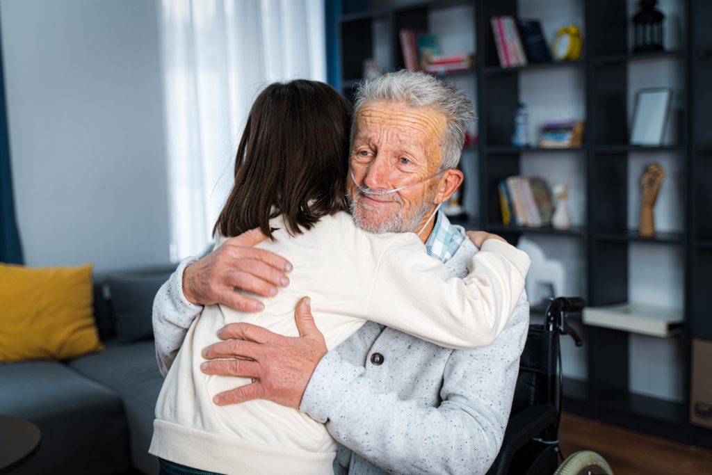 Little girl embracing an older gentleman